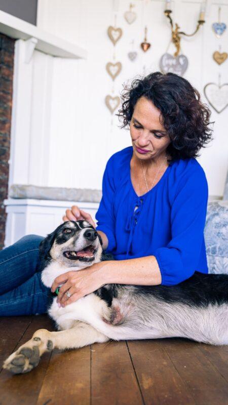 Image of woman with three legged dog